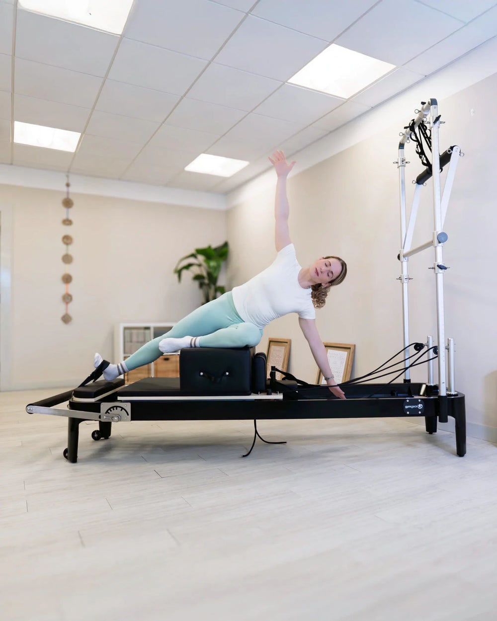 Person using a Gym Gear Aluminium Reformer with Tower System / Half Trapeze  in a clinical setting