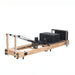 Pilates reformer machine on a white background