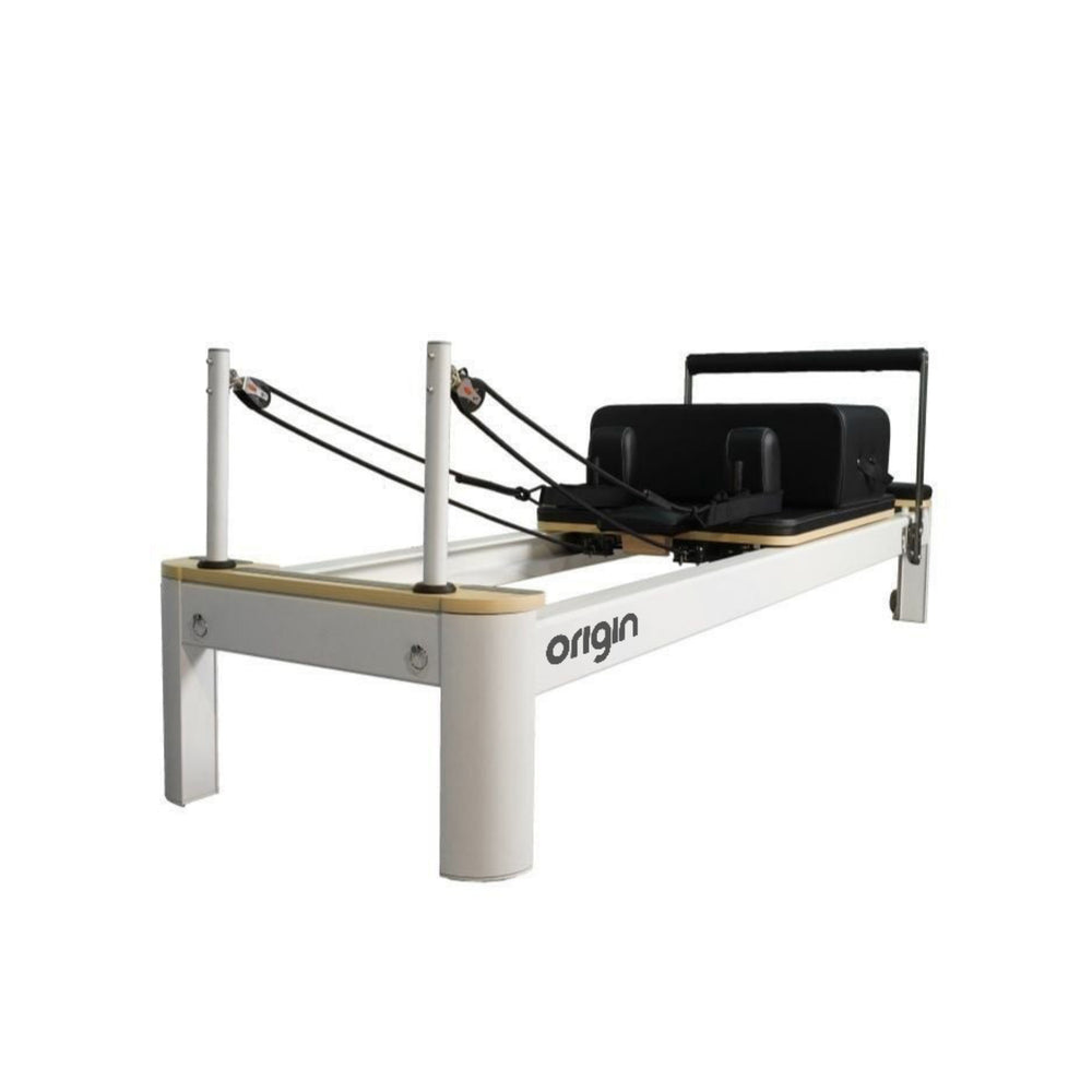 Origin Commercial Aluminium Studio Pilates Reformer Machine with a white frame, natural wood carriage, and black padded carriage, shown against a solid white background.
