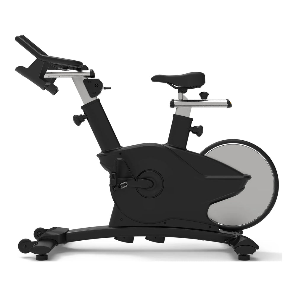 Origin Fitness Impulse PS450 Commercial Indoor Cycle with an adjustable seat, padded handlebars, and a large circular flywheel, shown on a plain white background.
