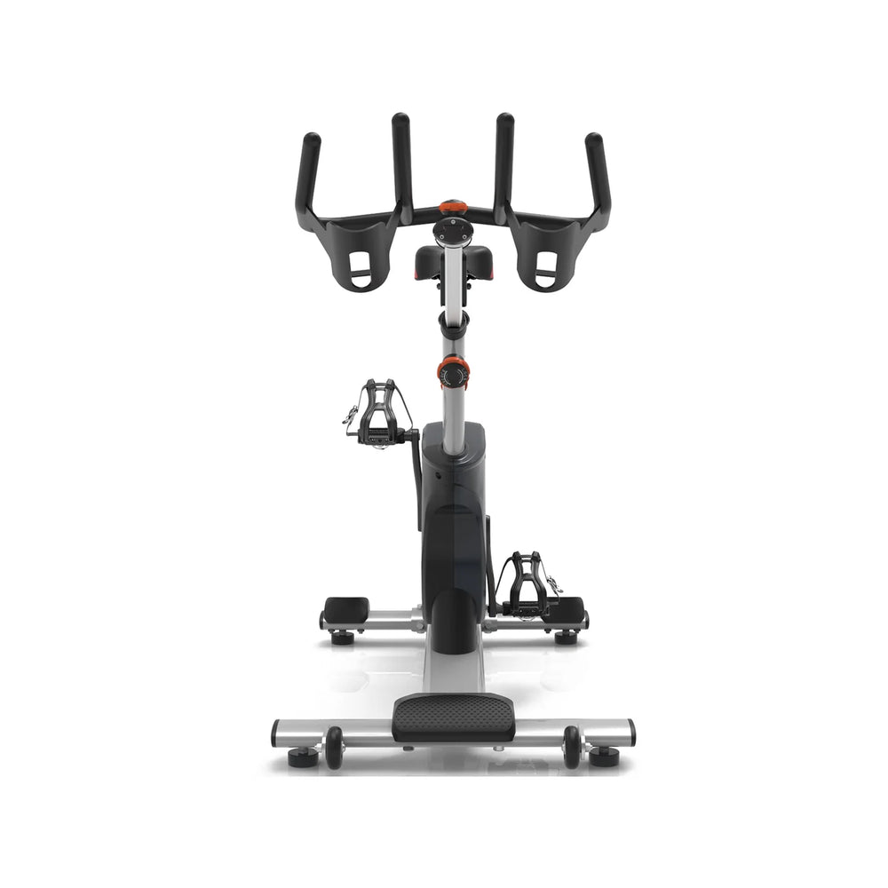 Origin Fitness Impulse PS450 Commercial Indoor Cycle with a black and silver frame, black handlebars, and black pedals, photographed from a front-facing perspective on a clean white background.
