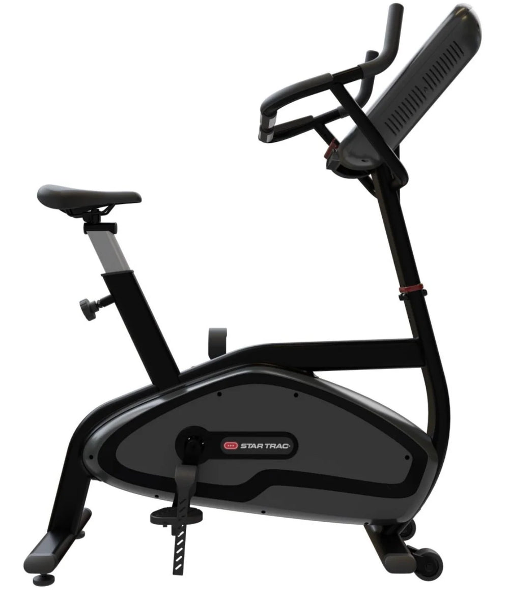 A Star Trac indoor exercise bike with a black and dark gray frame, featuring an adjustable saddle, padded handlebars, and a built-in display screen, shown against a plain white background.
