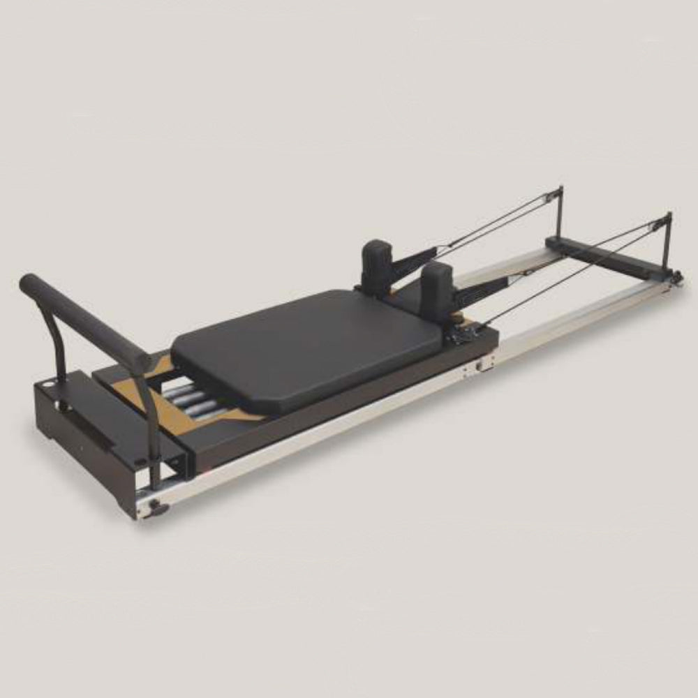 Pilates reformer machine on a light gray background