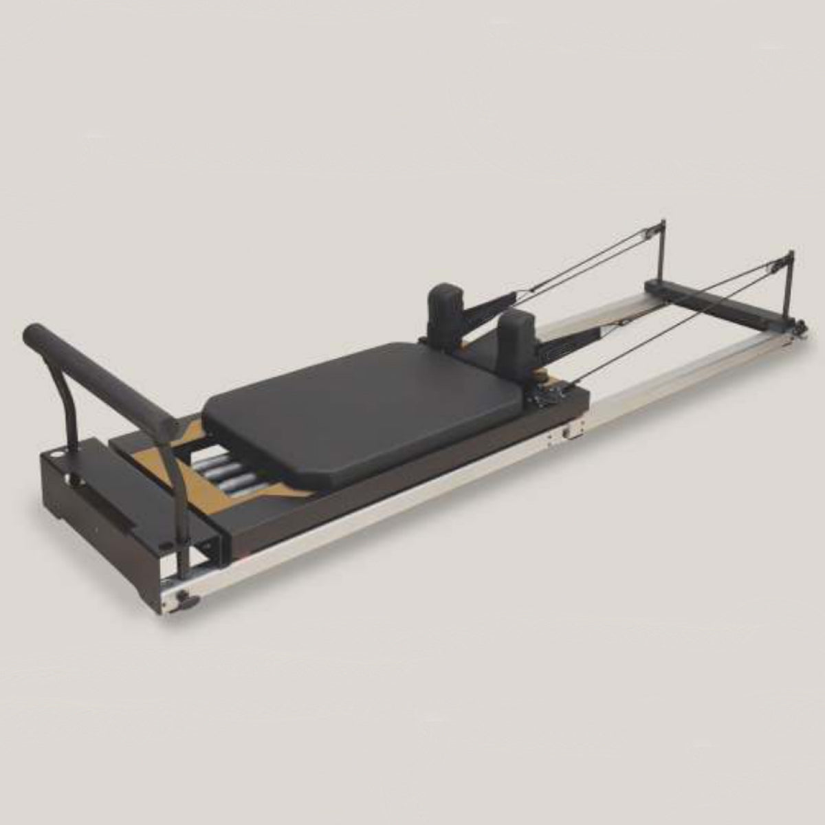 Pilates reformer machine on a light gray background