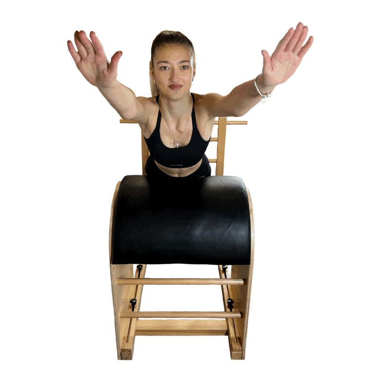 A woman with a black padded roller, holding her arms out to the sides against a plain white background.