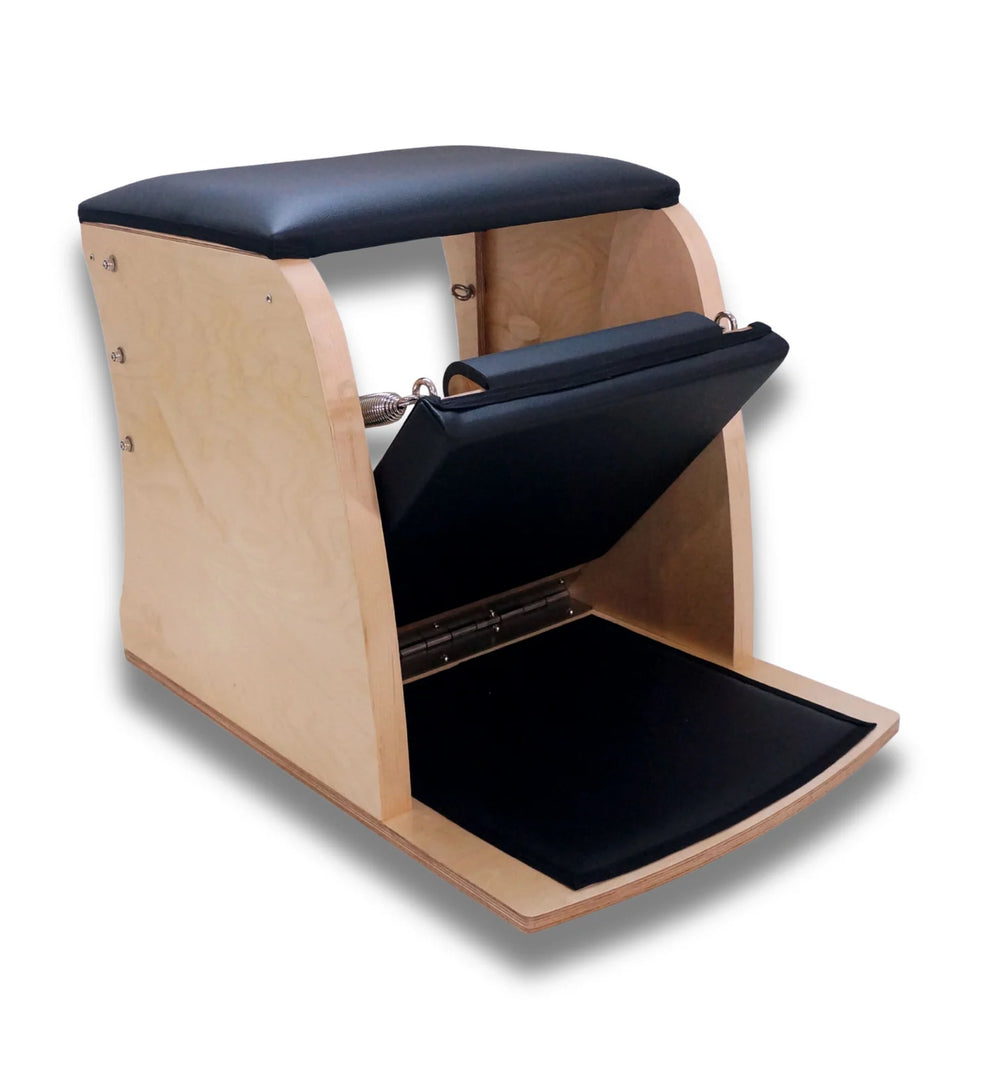 Origin Fitness Pilates Combo Chair with black padded seat, footrest, and handlebar, shown on a white background.